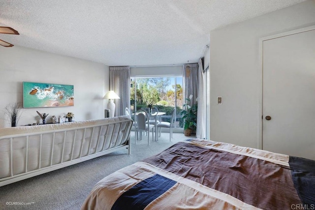 bedroom with a textured ceiling and carpet floors