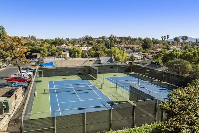 view of tennis court with a mountain view