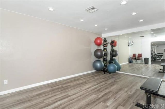 workout room with wood-type flooring