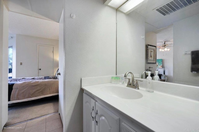 bathroom featuring ceiling fan, tile patterned flooring, and vanity