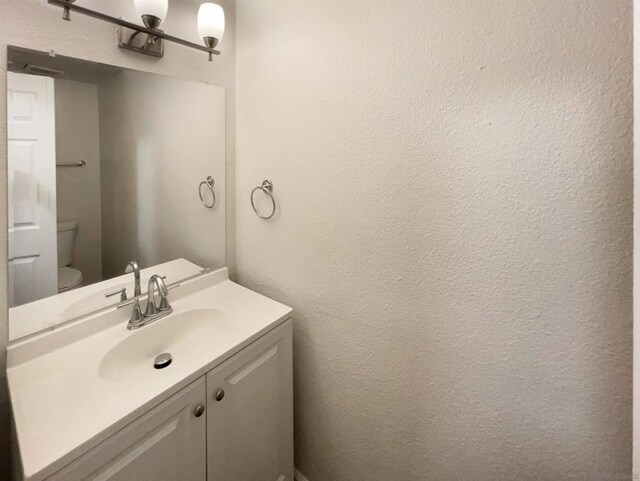 bathroom with toilet and vanity