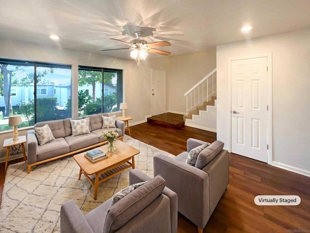 living room featuring ceiling fan and wood-type flooring