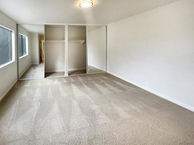 unfurnished bedroom featuring light colored carpet