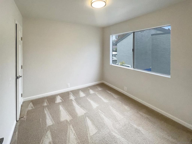 empty room featuring light colored carpet