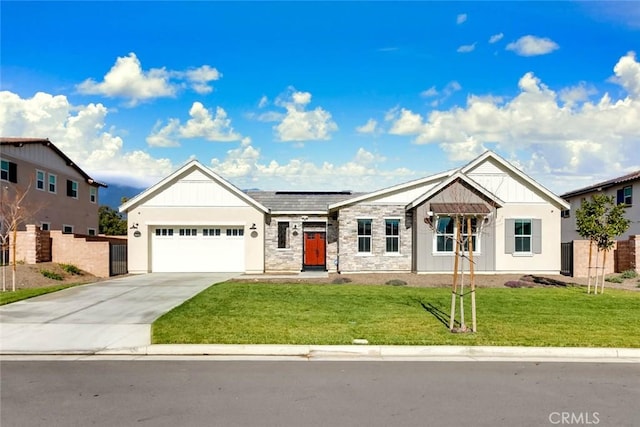 view of front of home featuring a garage, a front yard, and solar panels