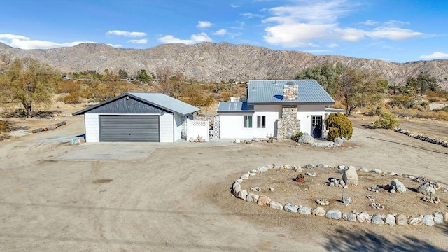 view of front of property with a garage and a mountain view