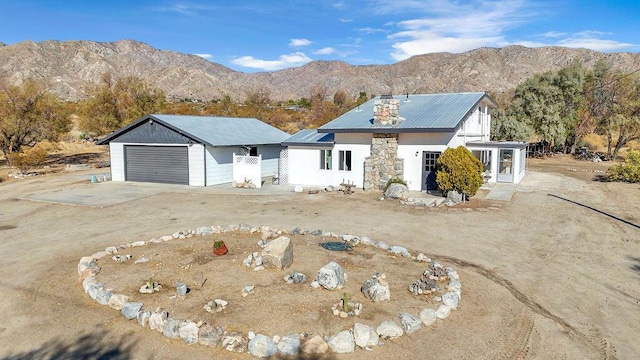 view of front of home with a garage and a mountain view