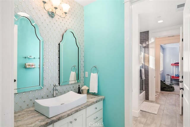 bathroom featuring tile patterned floors, vanity, a chandelier, and combined bath / shower with glass door