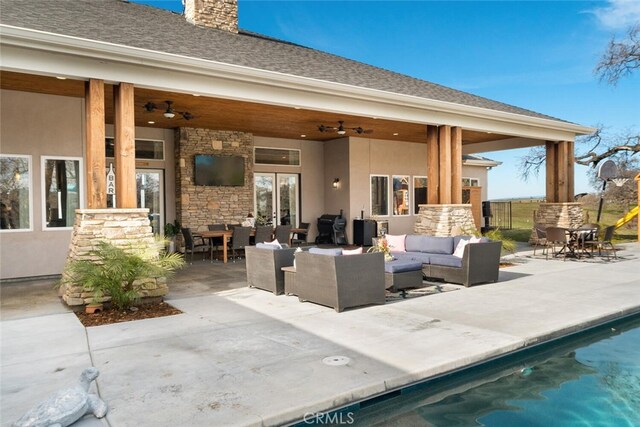 exterior space with an outdoor living space and ceiling fan