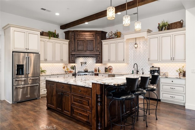 kitchen featuring beamed ceiling, stainless steel appliances, and dark hardwood / wood-style floors