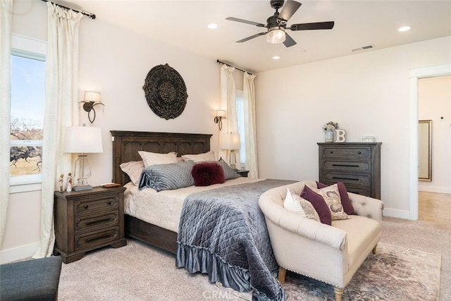 bedroom with ceiling fan and light carpet