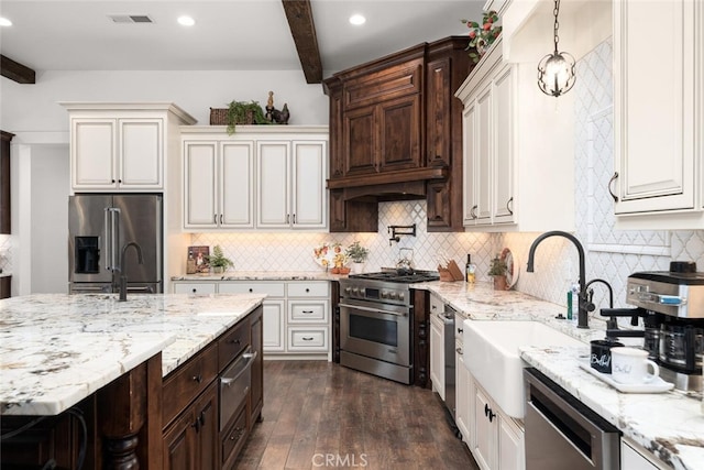 kitchen with hanging light fixtures, tasteful backsplash, premium appliances, beam ceiling, and dark hardwood / wood-style flooring