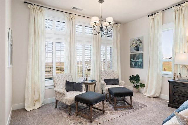 living area with light carpet, a chandelier, and plenty of natural light