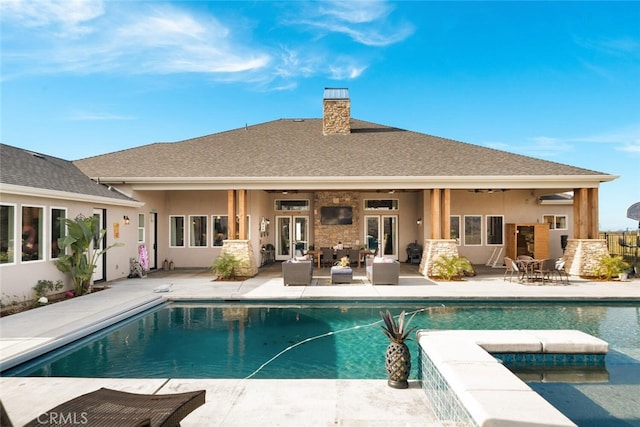 back of house featuring outdoor lounge area and a patio area