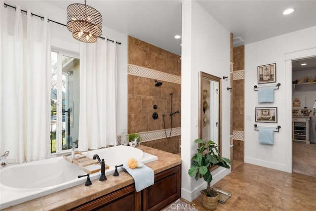 bathroom featuring shower with separate bathtub