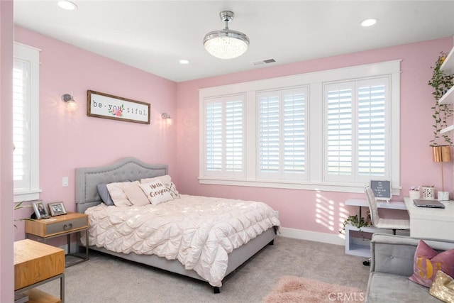 carpeted bedroom with multiple windows