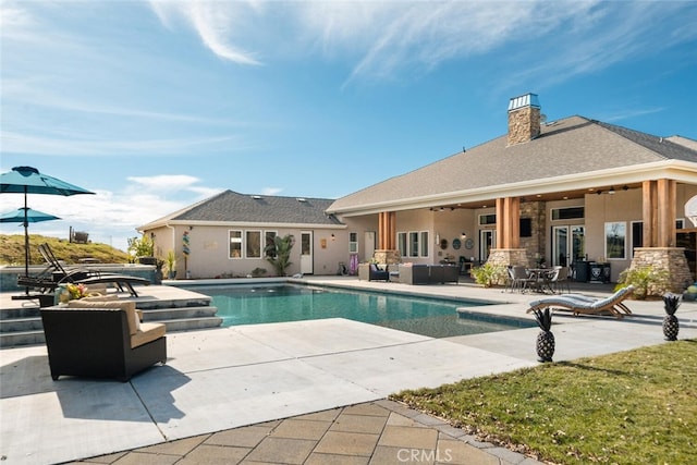 view of swimming pool featuring an outdoor living space and a patio