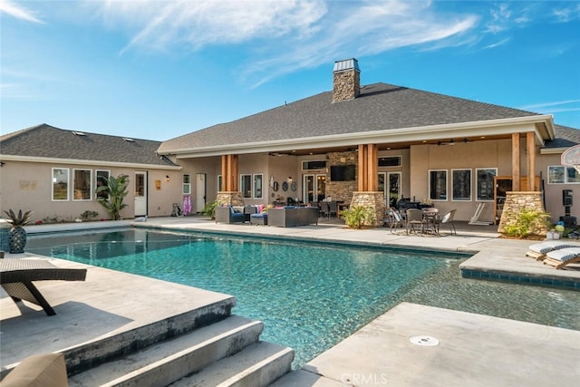 view of swimming pool with ceiling fan, an outdoor hangout area, and a patio