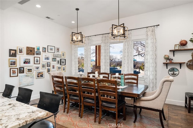 dining room featuring an inviting chandelier and dark wood-type flooring