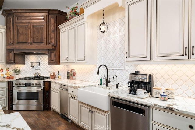 kitchen featuring sink, stainless steel appliances, dark hardwood / wood-style flooring, pendant lighting, and decorative backsplash