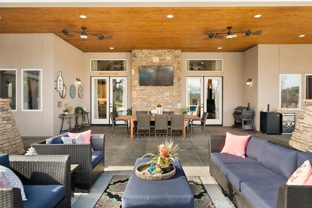 view of patio / terrace featuring ceiling fan, french doors, and an outdoor living space