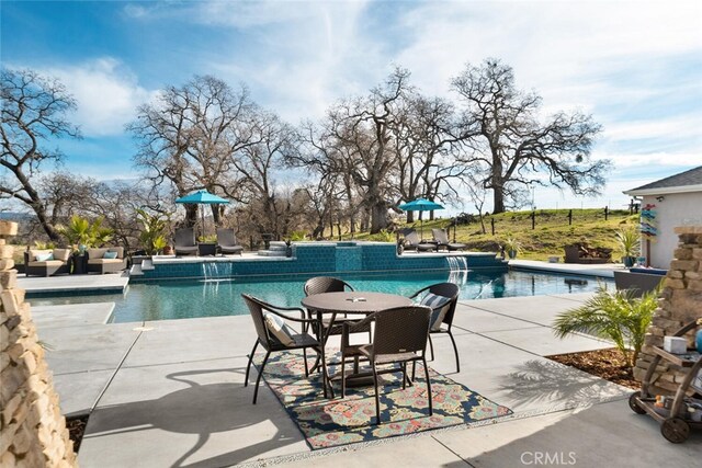 view of pool with pool water feature and a patio area