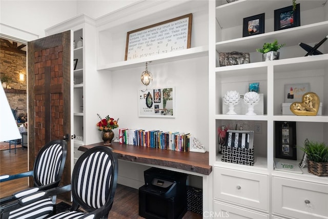 office space featuring dark hardwood / wood-style floors and built in desk