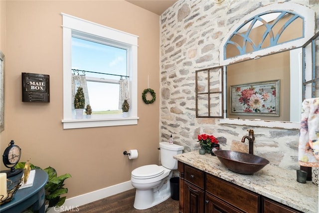 bathroom featuring hardwood / wood-style floors, vanity, and toilet