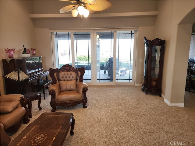 living area with ceiling fan and carpet floors