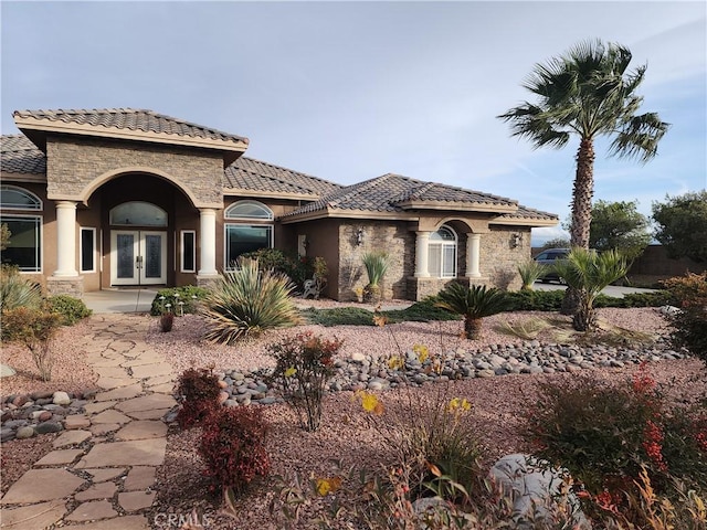 mediterranean / spanish-style home with french doors