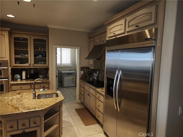 kitchen featuring a kitchen island with sink, crown molding, sink, light tile patterned floors, and appliances with stainless steel finishes