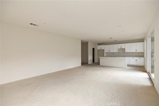 unfurnished living room with sink