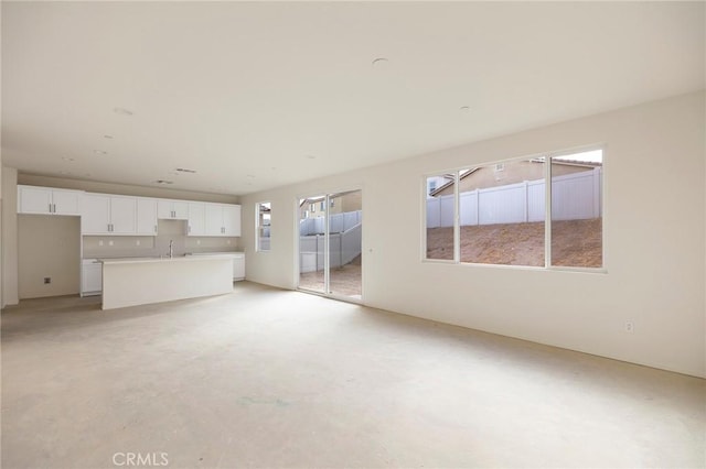 unfurnished living room featuring sink