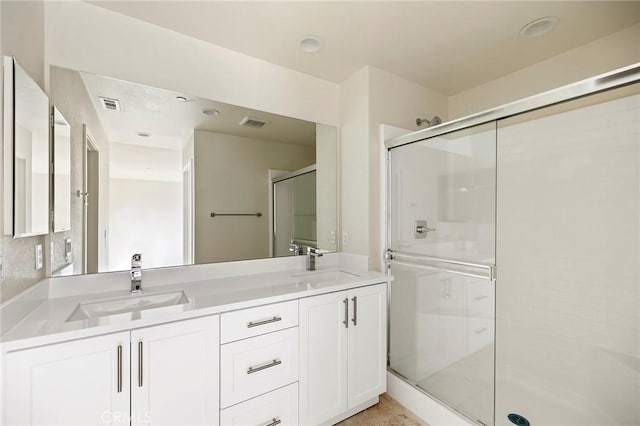 bathroom featuring vanity and a shower with shower door