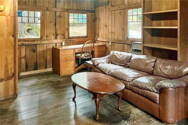 sitting room featuring dark wood-type flooring and wood walls