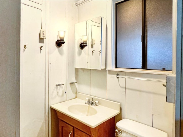 bathroom featuring vanity and toilet