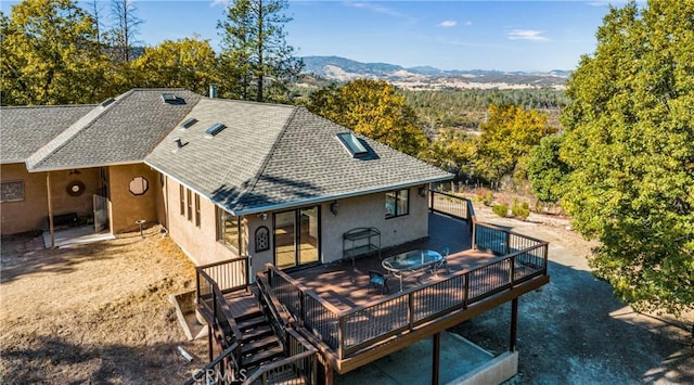 back of house with a deck with mountain view