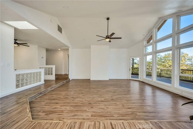 interior space with ceiling fan, light wood-type flooring, and high vaulted ceiling