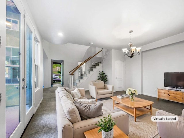 living room featuring french doors and a notable chandelier