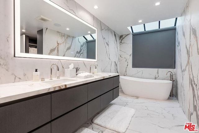 bathroom featuring a washtub, tile walls, and vanity