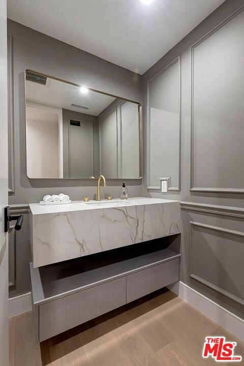 bathroom featuring hardwood / wood-style floors and vanity