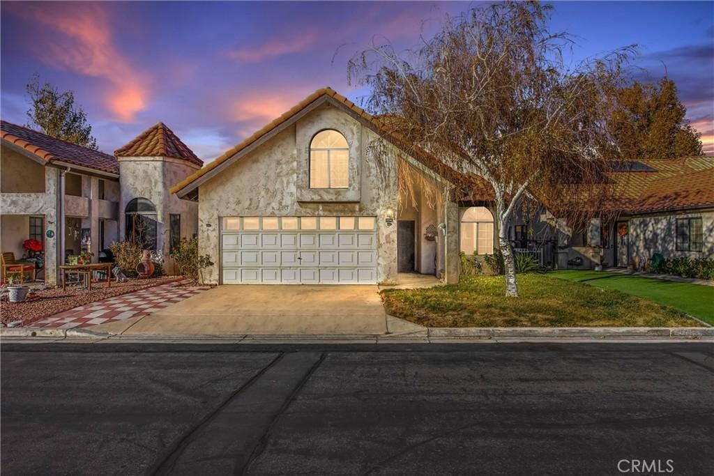 view of front facade with a yard and a garage