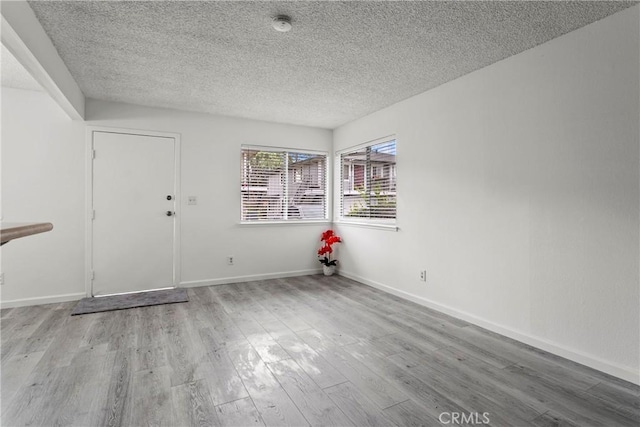 interior space featuring a textured ceiling and light hardwood / wood-style flooring