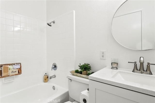 full bathroom featuring vanity, tiled shower / bath, and toilet