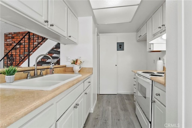 kitchen with sink, white cabinets, and white electric range