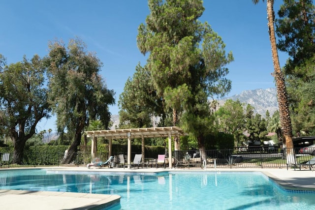 view of pool featuring a mountain view and a pergola