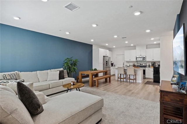 living room with light hardwood / wood-style floors