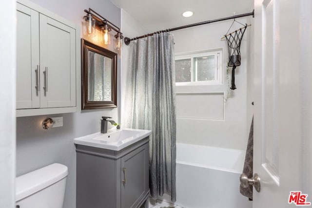 full bathroom with shower / tub combo, vanity, and toilet