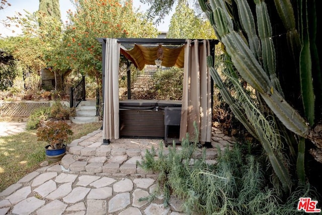 view of patio / terrace with a hot tub