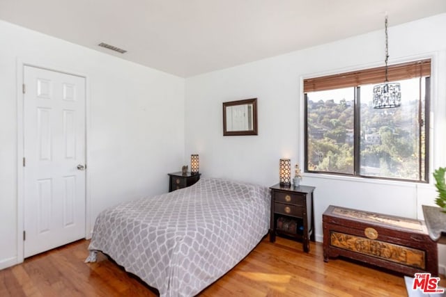 bedroom with wood-type flooring